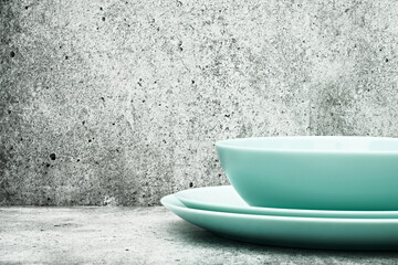 A stack of dishes on a light background. Glass set of dishes for the kitchen. close up.