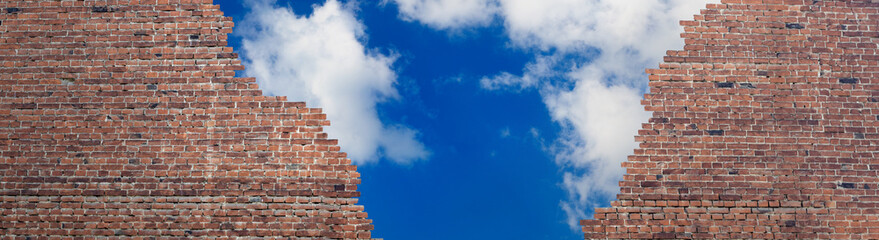 image of a brick wall fragment and blue sky behind a brick wall