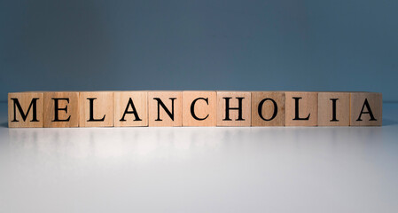Text of melancholia from wooden cubes. psychological terms and health problems.