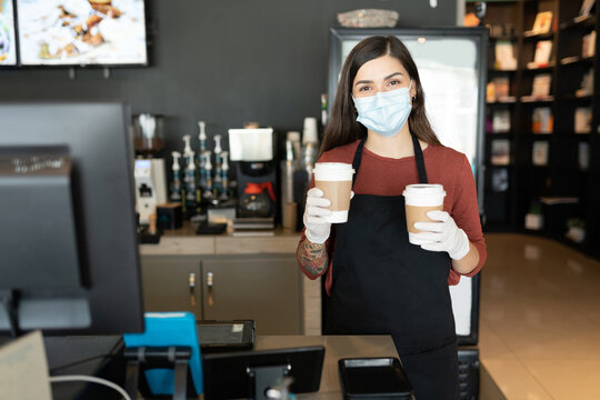 Barista With Face Mask Serving Coffee