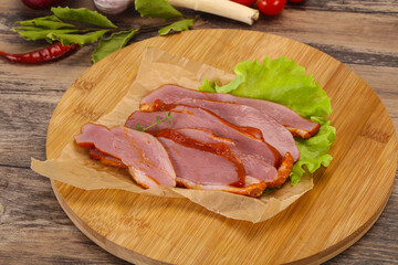 Sliced smoked duck breast served salad