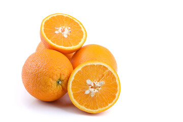 Fresh fruit: oranges, whole and cut into halves, isolated on a white background, close-up
