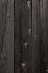 Naklejka premium Wood texture. Old black boards with knots. 