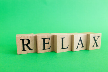 The word relax made from wooden cubes. Rest and calm concept.