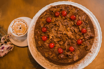 cherry and chocolate cake, wish coffee cup, selective focus