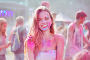 Gorgeous girl all in the paint. Girl with long hair at the Holly festival of colors. The girl...
