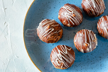 Mini puff cakes with vanilla pudding topped with chocolate