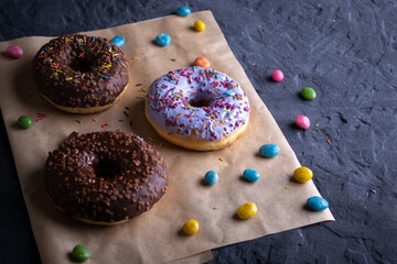 Donuts on a wooden board on a blue concrete background