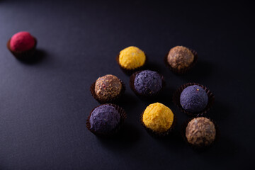 Colored round candies on a dark background