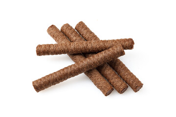 Heap of chocolate waffle rolls isolated on white background with shadows and grit. Close-up