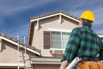 Contractor Overlooking Freshly Painted House