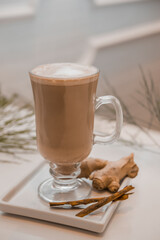 special coffee cup with cream and spices on light background
