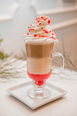 special coffee cup with cream and spices on light background