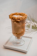 special coffee cup with cream and spices on light background