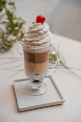 special coffee cup with cream and spices on light background