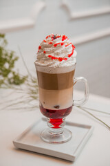 special coffee cup with cream and spices on light background