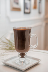 special coffee cup with cream and spices on light background
