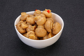 Pickled champignons in the bowl