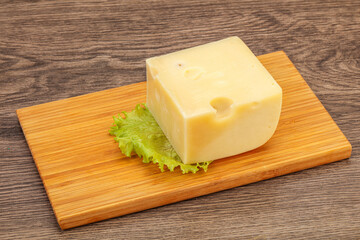 Emmental cheese over wooden board