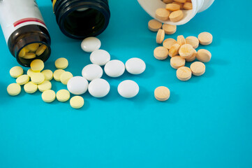 jars with pills on blue background