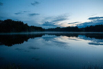 Dusk over a reflective calm lake
