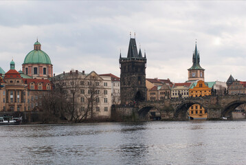 Fototapeta na wymiar Panorama of the city of Prague, Czech Republic on a sunny day. View of Charles Bridge and the bank of the Vltava River.
