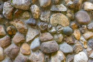 Fragment of an ancient wall made of natural stone