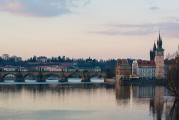 Fototapeta premium Panorama of the city of Prague, Czech Republic on a sunny day. View of Charles Bridge and the bank of the Vltava River.