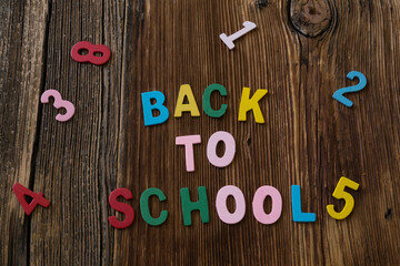 Colorful numbers and letters on the wooden background for back to school concept.