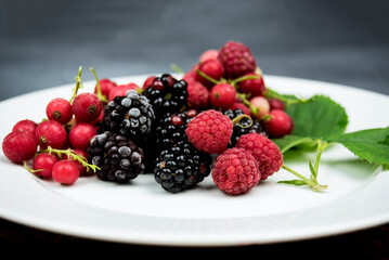 berries of summer on a white dish