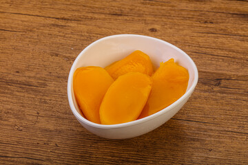 Naklejka na ściany i meble Sweet mango slices in syrop