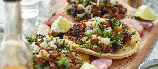mexican street tacos with carne asada on corn tortillas platter