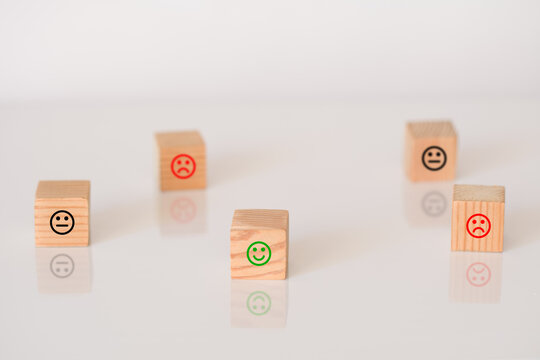 Wooden cubes with the image of smile face emotion. Customer survey feedback, customer rating concept.