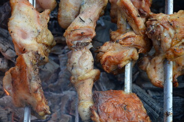 Grilled kebab cooking on metal skewer. Roasted meat cooked at barbecue. BBQ fresh beef meat chop slices. Traditional eastern dish, shish kebab. Grill on charcoal and flame, picnic, street food.