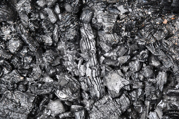 Black and gray abstract texture of cooling down wooden coal and cinders