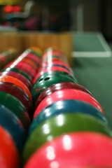 Multi Colored bowling balls lie in several rows - 361852407