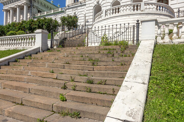 An old open outer stone staircase. Stone, cement steps of the old staircase with traces of...