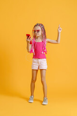 Beautiful European girl with dreadlocks. Mobile phone in the hand.