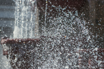 Background from many drops of water from a city fountain.