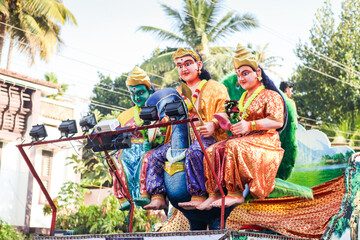 different big statues of traditional Indian gods ride on open platform at religion feast