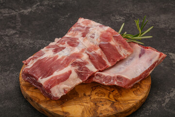 Raw pork ribs served rosemary