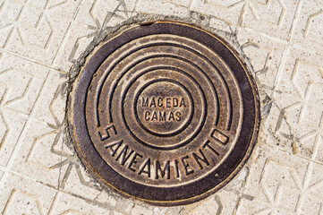 iron canal cover between the concrete pavement