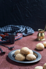(kahk) a traditional arabic Egyptian muslim cookie home made shot on a red table with black background