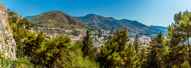 Fototapeta na wymiar A panorama view above the tree line from the mesa behind the town of Cefalu, Sicily in summer