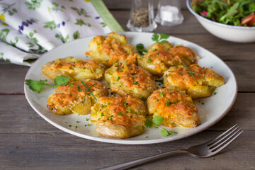 Smashed new baby potatoes with garlic and cheese. Healthy vegetarian food
