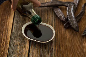 Traditional Harnup molasses  on the wooden background.