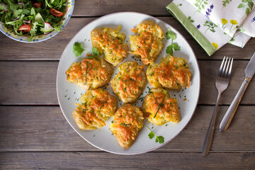 Smashed new baby potatoes with garlic and cheese. Healthy vegetarian food. View from above, top studio shot