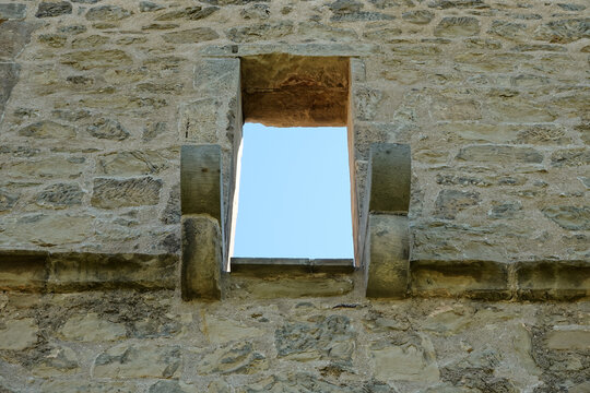 Brown window in a brick castle, blue sky. Germany.