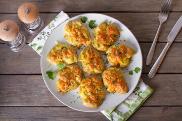 Smashed new baby potatoes with garlic and cheese. Healthy vegetarian food. View from above, top studio shot