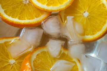 Fototapeta na wymiar Top view of chill water infused with sliced oranges which is good in vitamin c. Immunity boosting drink.